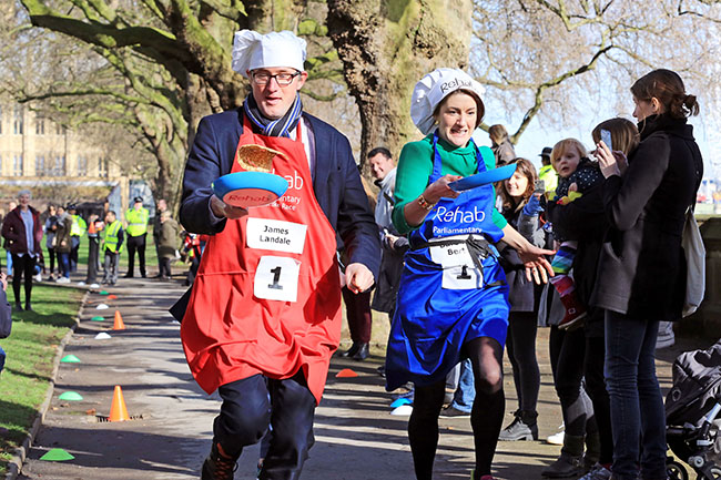 James Landale, BBC News and Baroness Bertin pictured at the Rehab Parliamentary Pancake Race 2017 in which the MPs’ team secured victory for the second year in a row. The race, which took place outside the Houses of Parliament in Westminster today, this year celebrates 20 years of bringing MPs, Lords and members of the media together in a mad scramble to see who will come out sunny side-up. Organised by the Rehab disability charity, the race drew throngs of spectators and attracted media interest from around the globe. The 2017 race saw the defending champions - the MPs' team - take on the Lords' and media teams in a determined effort to secure two-in-a-row. For more, see www.parliamentarypancakerace.co.uk